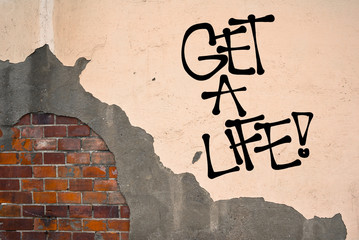Get a life - handwritten graffiti sprayed on the wall - appeal to life productive, meaningful and active life.