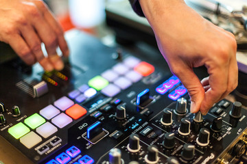 close-up photography of dj hands mixing music in a club, selective focus.