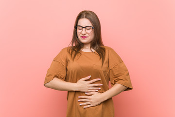 Young student woman wearing eyeglasses sick, suffering from stomachache, painful disease concept.