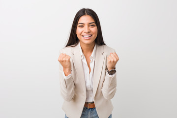 Young business arab woman isolated against a white background cheering carefree and excited....