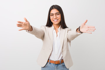 Young business arab woman isolated against a white background feels confident giving a hug to the camera.