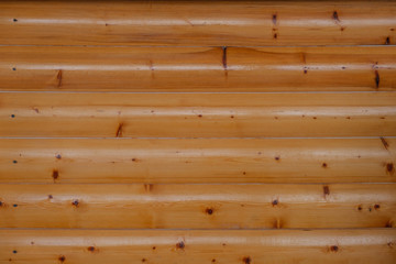 Seamless background of polished logs. The natural color of the tree.