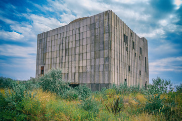 Fototapeta na wymiar Abandoned nuclear power plant on a background of blue sky. Easy toning of the image.