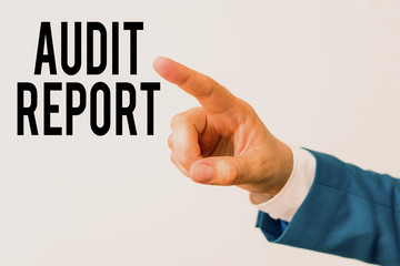 Writing note showing Audit Report. Business concept for An appraisal of complete financial status of a business Assets Isolated hand pointing with finger. Business concept pointing finger