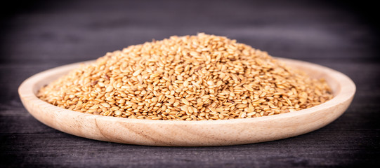 Toasted sesame seed on wooden plate