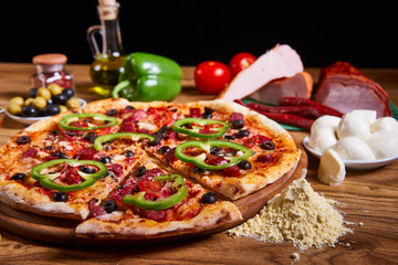 Pizza margarita with tomato sauce, fresh mozzarella, parmesan on the wooden rusty background. Hot big pepperoni pizza, tasty pizza composition