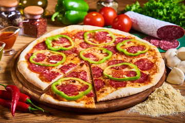 Pizza margarita with tomato sauce, fresh mozzarella, parmesan on the wooden rusty background. Hot big pepperoni pizza, tasty pizza composition