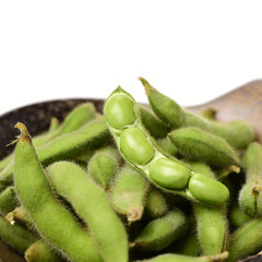 A pile of fresh soybeans on a white background.