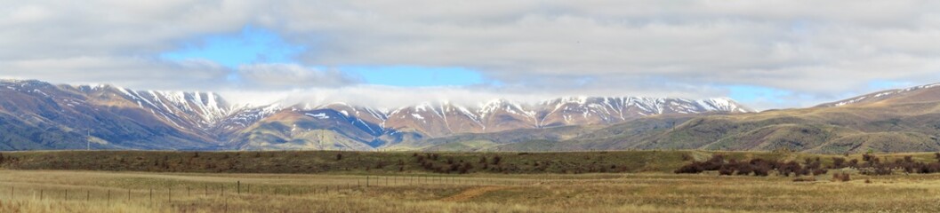 Snow capped mountains along roadside on South Island New Zealand