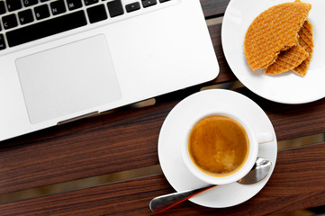 cup of coffee and laptop on table