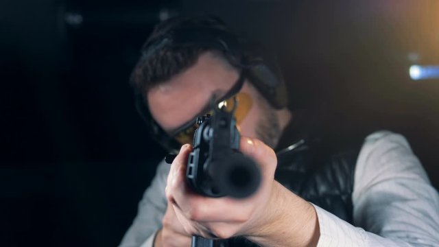 Person with a training rifle in a room, close up.