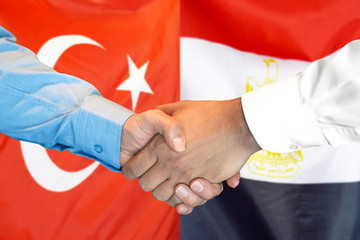 Business handshake on the background of two flags. Men handshake on the background of the Turkey and Egypt flag. Support concept