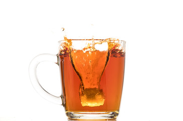 making black tea from a bag with sugar in motion on a white background