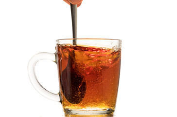 making black tea from a bag with sugar in motion on a white background