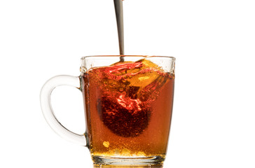 making black tea from a bag with sugar in motion on a white background