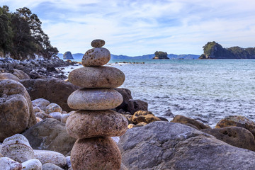stack of stones on beach at Cathedral Cover North Island New Zealand