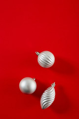 Silver  Christmas Ball on red background flat lay