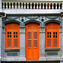 Peranakan shop house with Orange shutters and doors.