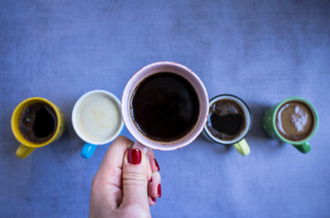 Coffee cup in woman hand, close up, top view. Copy space