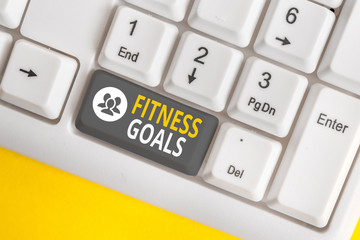 Word writing text Fitness Goals. Business photo showcasing Loose fat Build muscle Getting stronger Conditioning White pc keyboard with empty note paper above white background key copy space