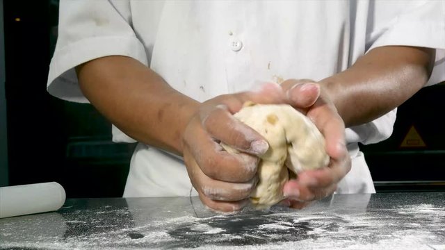 4k video of the hands of a man preparing sourdough bread with nuts and raisins