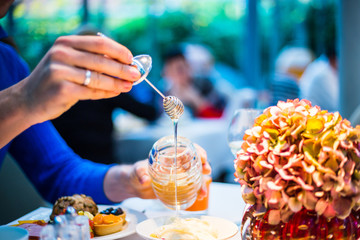 Breakfast Buffet Concept, Breakfast Time in Luxury Hotel, Brunch with Family in Restaurant, Mans Hand with Spoon of Honey