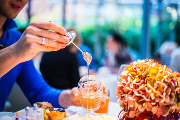 Breakfast Buffet Concept, Breakfast Time in Luxury Hotel, Brunch with Family in Restaurant, Mans Hand with Spoon of Honey