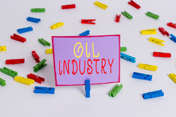 Conceptual hand writing showing Oil Industry. Concept meaning Exploration Extraction Refining Marketing petroleum products Colored clothespin papers empty reminder white floor office