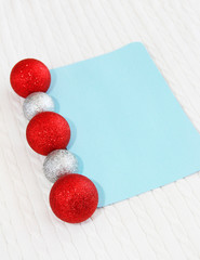 Christmas card with toys New Year's balls on a white fabric background with a braid pattern