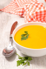 pumpkin or carrot soup in bowl