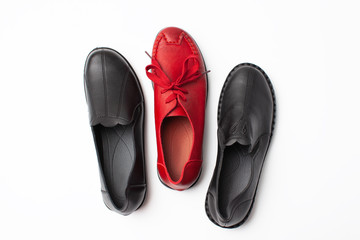 Set of autumn black shoes and one red on white background