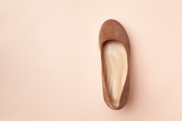Brown suede female Shoe on a pink background. Top view