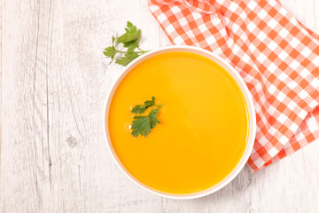 pumpkin or carrot soup in bowl