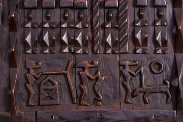 Detail of African Dogon Granary window hand carved in wood. - obrazy, fototapety, plakaty