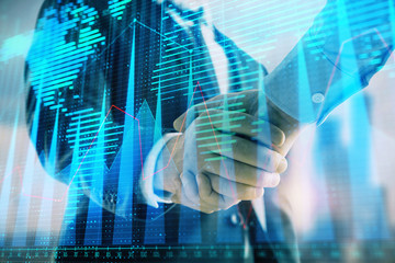 Double exposure of financial chart and world map on cityscape background with two businessmen handshake. Concept of international investment