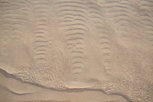 Textured Sand Ripples Under Clear Shallow Water