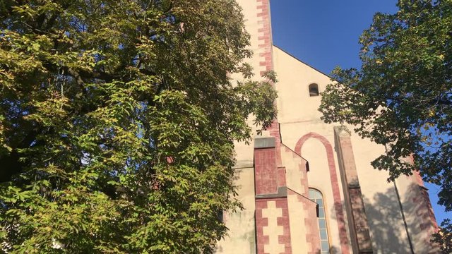 Tourist attraction in Banska Bystrica, Slovakia - Church of the Assumption of the Blessed Virgin Mary. Old gothic church. Exterior in sunny day. Parish church.
