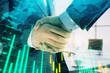 Multi exposure of financial chart and map on office background with two businessmen handshake. Concept of success in business