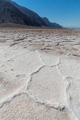 Fototapeta na wymiar Low angle view of the rough surface on the salt lake of Badwater Basin, under a blue sky with no clouds