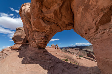 Wide angle view of the Delicate Arch as seen from an opposing stone arch