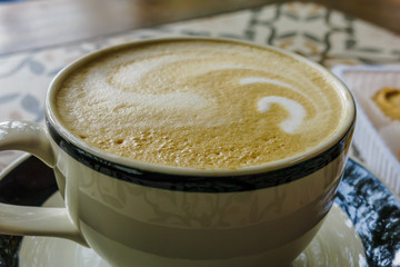 Cup of coffee latte in coffee shop
