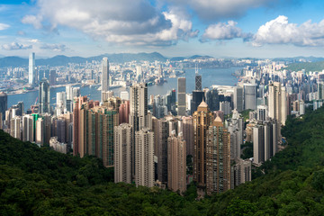Fototapeta na wymiar Aerial view of Hong Kong skyline and Victoria Harbor with blue sky in Hong Kong. Asia. Asian tourism, modern city life, or business finance and economy concept.