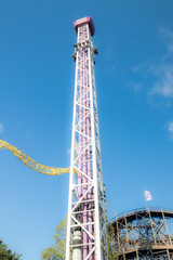 Helsinki, Finland - 14 September 2019: Linnanmaki amusement park, rides tower Raketti in motion and...