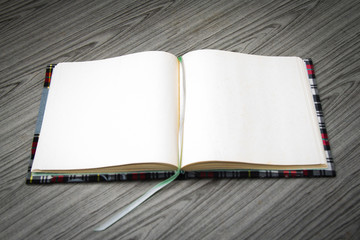 Open notebook on wooden desk .Blank notebook