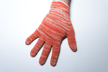 New construction gloves. knitted textile gloves on a white background. Protective equipment, safety measures. hands wearing gloves. for workers, builders and installers.