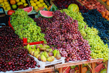 Berries in the market.Fruit tray on the street. Street food. Raspberries, blueberries, grapes. Golden Sands. Bulgaria