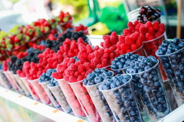 Berries in the market.Fruit tray on the street. Street food. Raspberries, blueberries, grapes. Golden Sands. Bulgaria