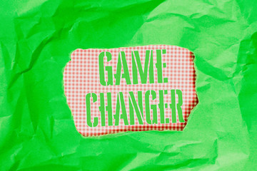 Text sign showing Game Changer. Business photo showcasing Sports Data Scorekeeper Gamestreams Live Scores Team Admins Green crumpled ripped colored paper sheet centre torn colorful background