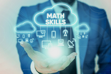 Handwriting text Math Skills. Conceptual photo starting to learn how to count numbers add divide use equation Male human wear formal work suit presenting presentation using smart device