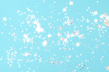 Fototapeta na wymiar Light blue background with many shiny stars.